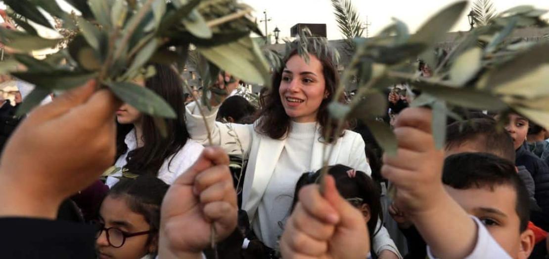 Iraqi Christians gather to celebrate Palm Sunday outside St. Elijah Church in Erbil, the capital of the autonomous Kurdish region of northern Iraq, 1 April 2023.