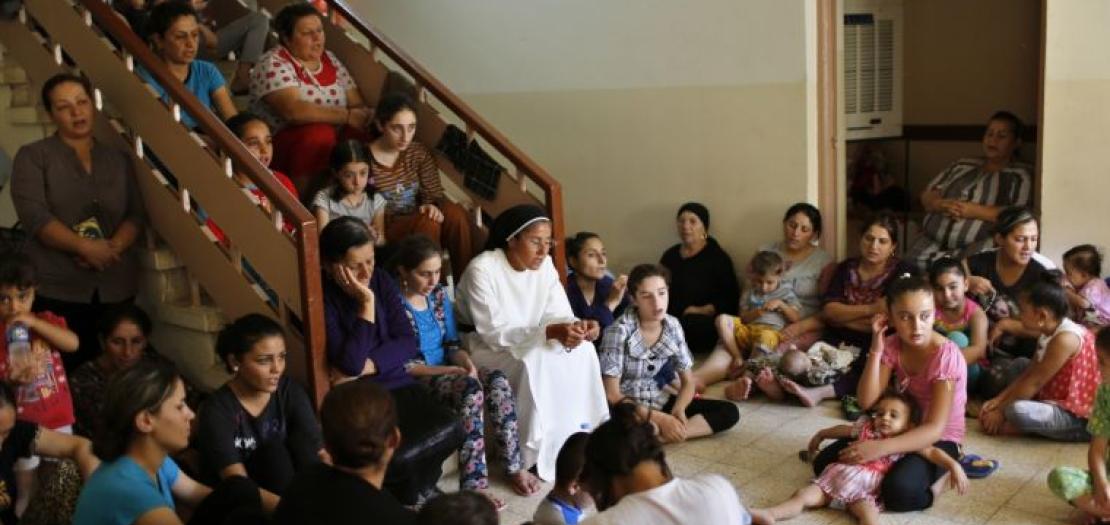 Displaced Iraq Christians who fled from Islamic State militants in Mosul, pray at a school acting as a refugee camp in Erbil, Iraq, September 6, 2014 