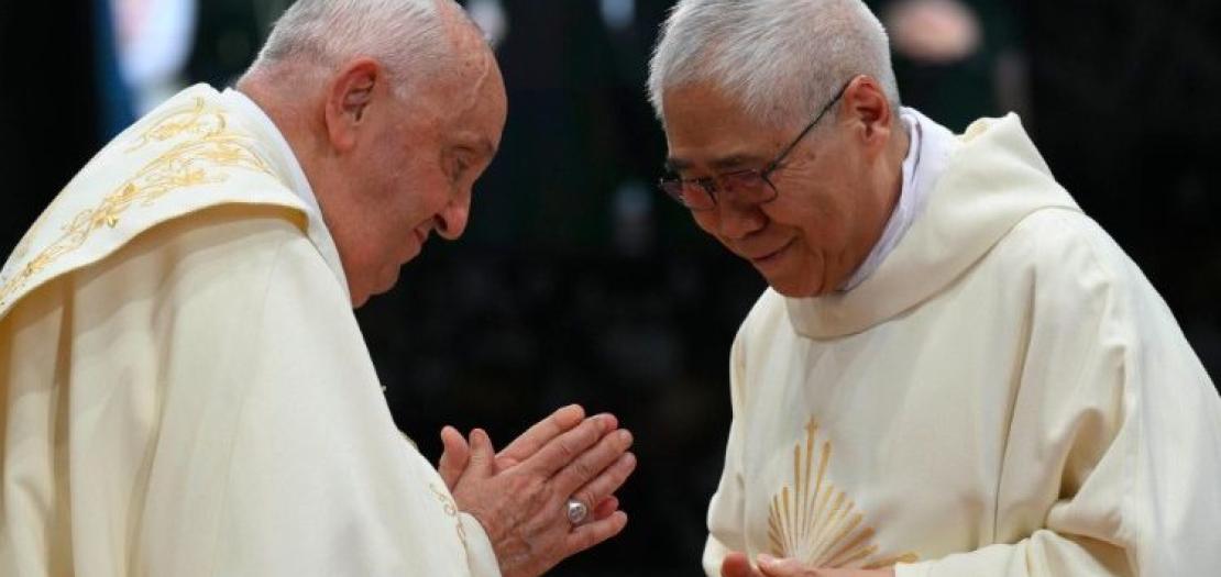 Pope Francis and Cardinal Goh exchange the sign of peace at Mass in Singapore on Thursday, September 13