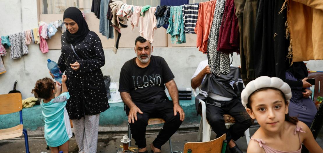 A family sits in a school turned into a temporary shelter for displaced people in Beirut Oct. 9, 2024, amid the ongoing hostilities. 