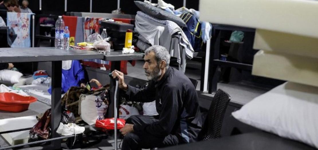 A man sits in a makeshift shelter after being displaced from his home in Lebanon  