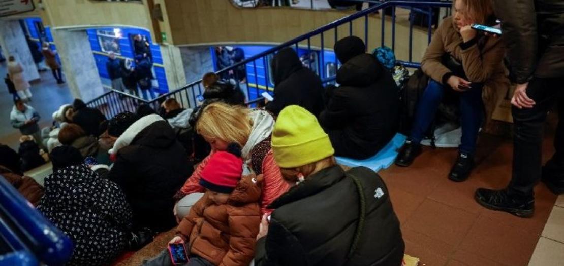 People take shelter inside a metro station during a Russian military attack in Kyiv 