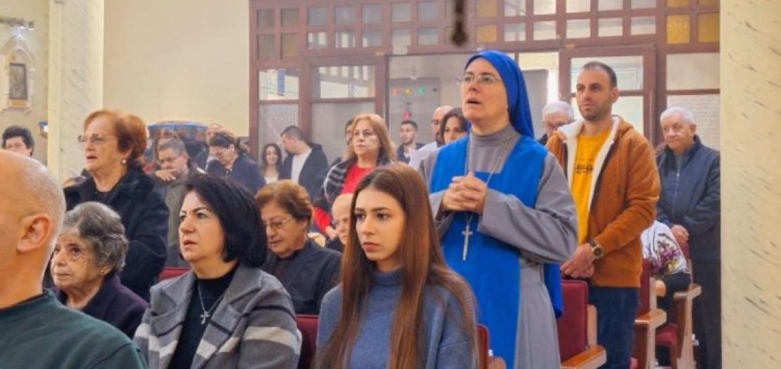 People attending Holy Mass led by the Patriarch of Jerusalem at Holy Family parish on December 22, 2024