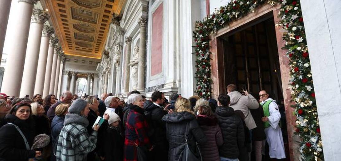 Visitors walk through the Holy Door of the Basilica of St. Paul Outside the Walls in Rome on Jan. 5, 2025, after its ceremonial opening by U.S. Cardinal James M. Harvey, archpriest of the basilica