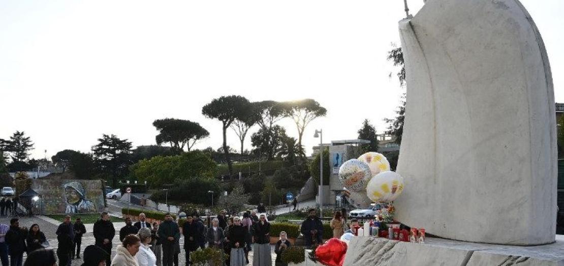 Several people gather outside Gemelli Hospital to pray for Pope Francis