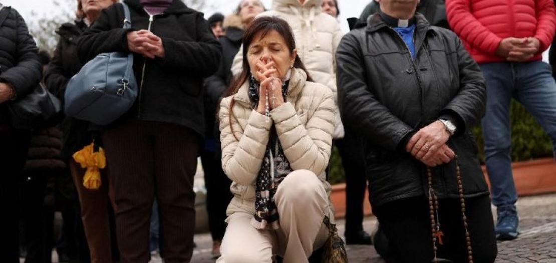 People pray for Pope Francis outside Rome's Gemelli Hospital in Rome, where the Holy Father is cotinuing to receive treatment  