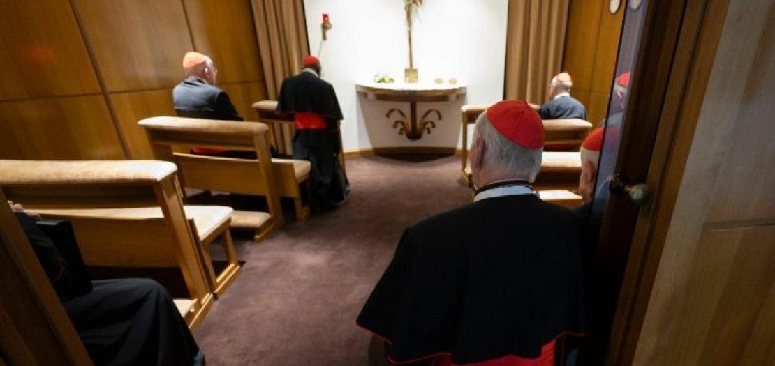 Cardinals pray before the Blessed Sacrament in a chapel near the New Synod Hall