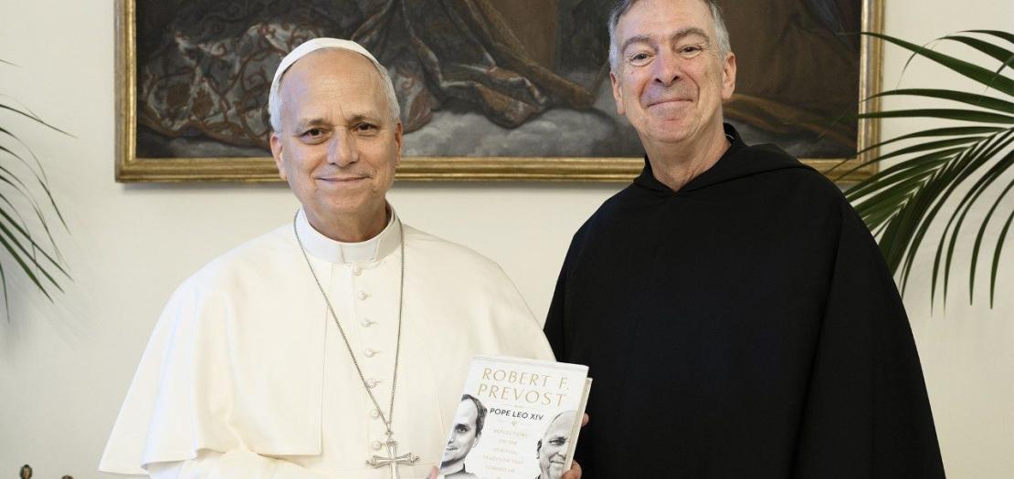 Pope Leo XIV poses for a photo with his book and Fr. Joseph Farrell, Prior General of the Order of St. Augustine  