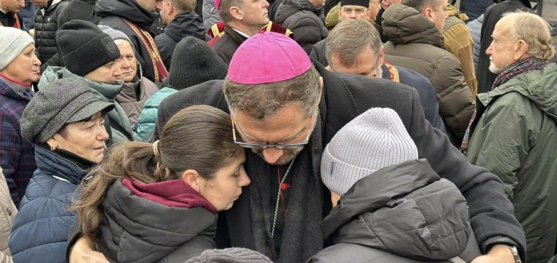 Archbishop Visvaldas Kulbokas with the families of victims of a Russian attack on Ternopil 
